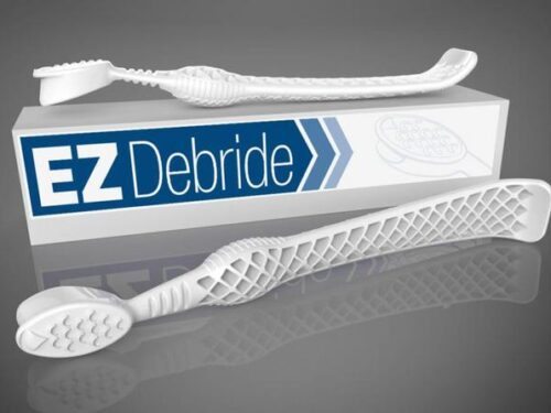 EZ Debride wound-care tools resting on their box, white textured surgical probes on a gray background.